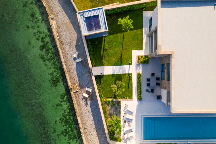 Overhead view of the villa's plot, with the flat roof, lawn, lap pool and terrace reading as a single plan.