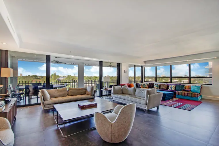 Seating and rug in the living room, with the terrace glazing running along one side.