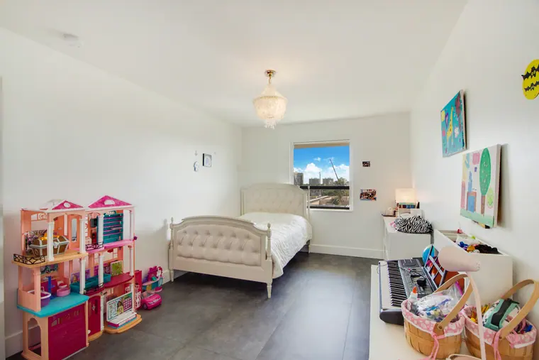 A child's bedroom, the bed set against the window wall.